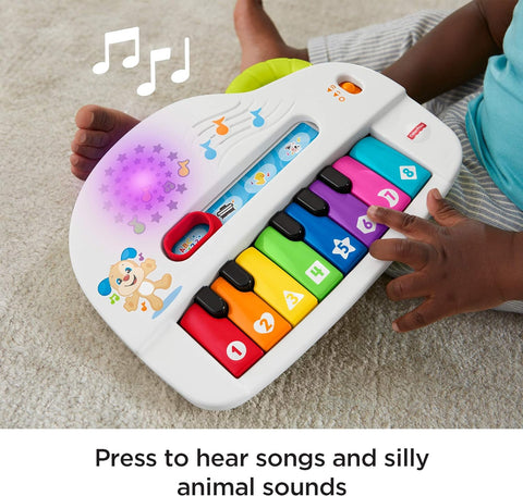 Fisher-Price Silly Sounds Light-Up Piano - UK English Edition, take-along toy piano with lights, real music notes and learning songs for baby and toddlers -- لعبة بيانو فيشر-برايس مضيء باصوات سخيفة مسلية للاطفال - ناطق باللغة الانجليزية